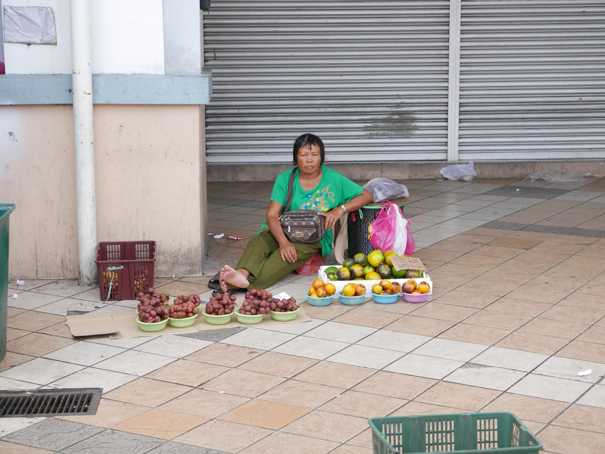 Photo by Author — stall-holder in the Sibu day market